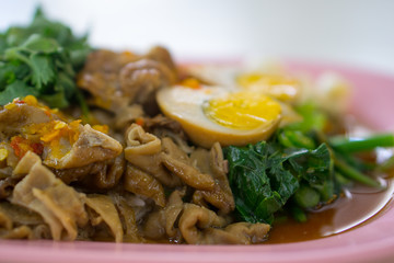 Stewed pork leg on rice with boiled egg.