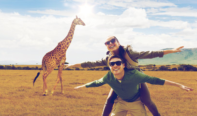 happy couple with backpacks having fun in africa - obrazy, fototapety, plakaty