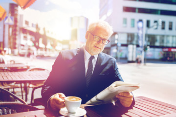 senior businessman with newspaper drinking coffee