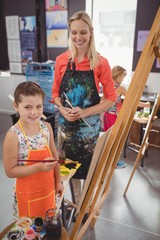Obraz premium Teacher assisting girl in drawing class
