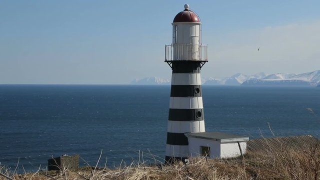 Petropavlovsky Lighthouse (founded in 1850) is located on Mayachny Cape on Kamchatka Peninsula on shore of picturesque Avacha Gulf in Pacific Ocean, in vicinity of Petropavlovsk-Kamchatsky City.