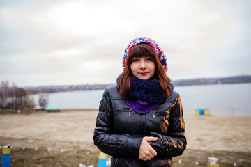Fototapeta na wymiar Portrait of young beautiful woman outdoor - standing on seaside