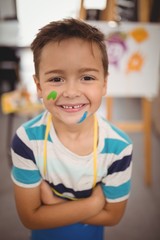 Obraz premium Smiling schoolboy with paint on face