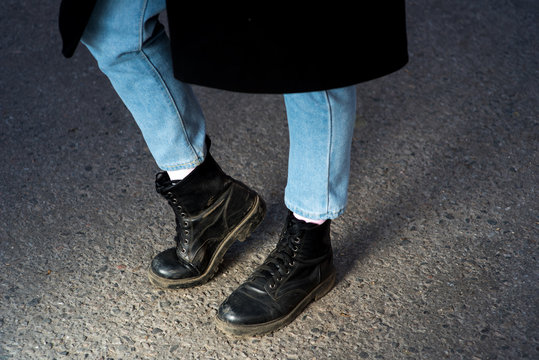 Stylish young fashionable girl with high heel winter boots and black leather bag. Winter street fashion look. Harajuku fashion