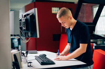 Young man working in printing factory