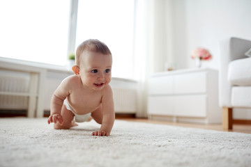 little baby in diaper crawling on floor at home - obrazy, fototapety, plakaty