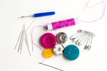 sewing buttons, needles, pins and thread spool