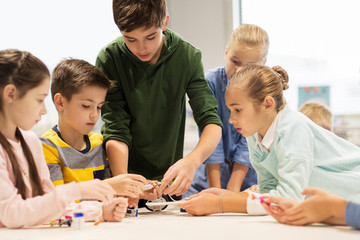 happy children building robots at robotics school