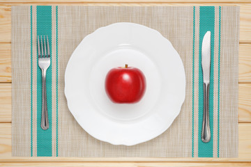 red apple on a white plate