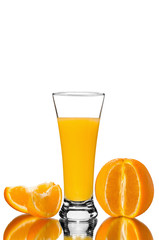 glass of orange juice and orange pieces