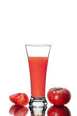Fresh tomatoes and a glass full of tomato juice