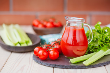 Tomato juice in a glass jar on a wooden table. Love for a healthy raw food concept.
