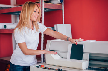 Young woman working in printing factory