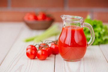 Tomato juice in a glass jar on a wooden table. Love for a healthy raw food concept.