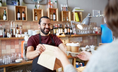 man or waiter serving customer at coffee shop