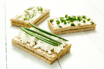 Three dietary snacks with cottage cheese and greens on a white wooden table, healthy food.