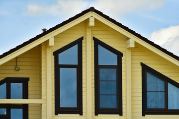 The facade of a wooden house with windows
