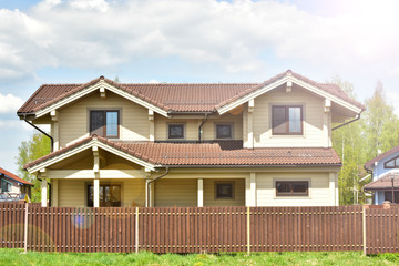 Modern beautiful wooden house and sun beams