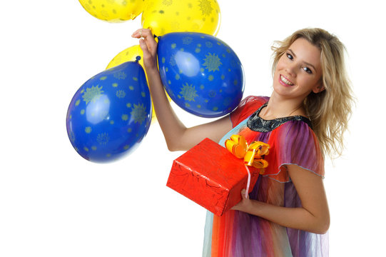 young beautiful female holding present and bunch of blue and yellow balloons studio isolated on white background