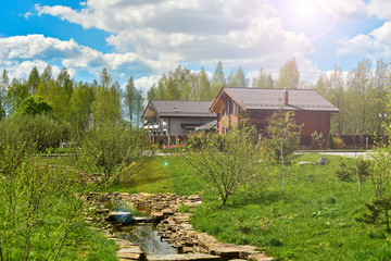 a small stream and wooden houses in the background