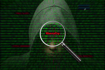 Hacker over a screen with binary code and WannaCry warning messages