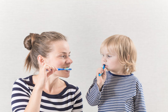 Mom With Baby Brushing Teeth