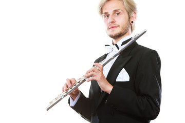 Male flutist wearing tailcoat holds flute