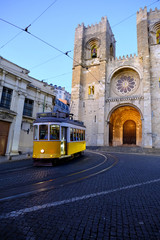 Fototapeta na wymiar Traditional yellow tram at old streets