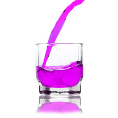 pink cocktail splashing on a glass on white background
