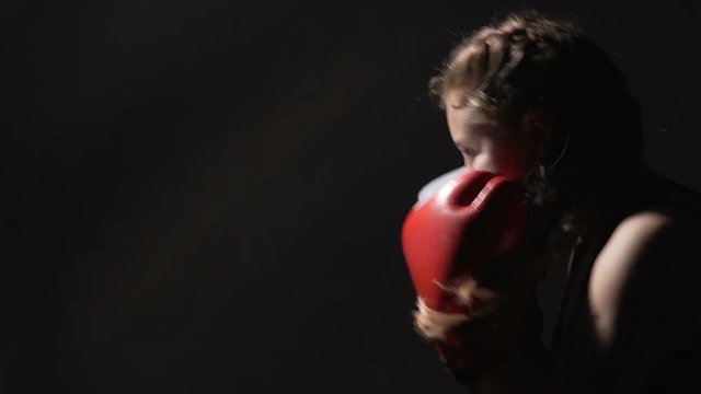 Muay Thai workout, strong lady kickboxing actively in the fitness club, sports