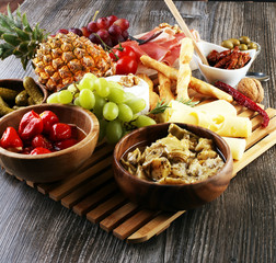 Italian antipasti wine snacks set. Cheese variety, Mediterranean olives, pickles, Prosciutto di...