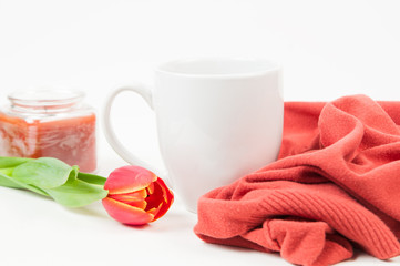 White desk top with various items on it with pops of orange colour