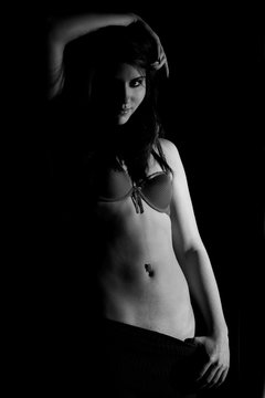 young slim female posing in bra. black and white picture