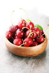 Cherry bowl with sweet cherries with leaf