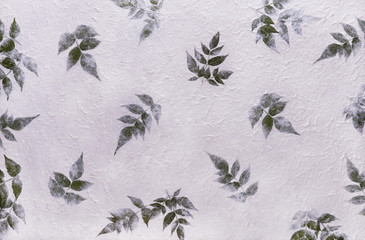 White mulberry paper with the texture of flowers and foliage is used as a background.