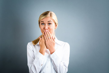 Young woman covering her mouth