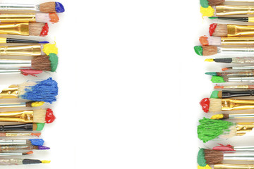 Row of artist paintbrushes closeup on artistic canvas.