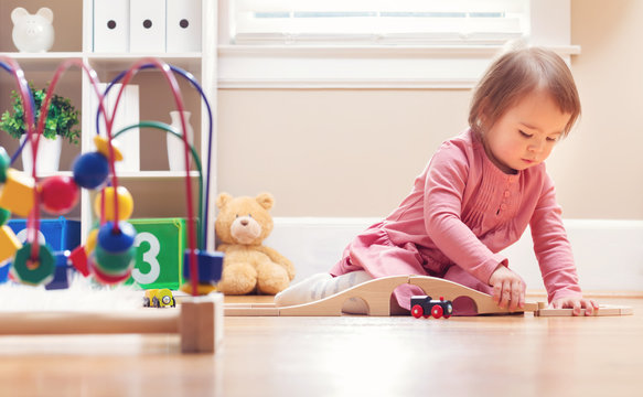 Happy Toddler Girl Playing With Toys