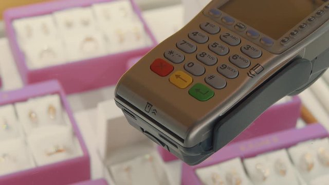 Typing Numbers Buttons On A Credit Card Terminal In A Jewelry Store