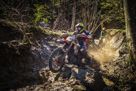 Motocross rider passes through the mud on the hardenduro race
