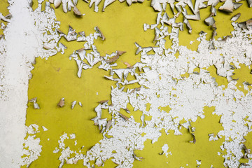 peeling paint on yellow wall