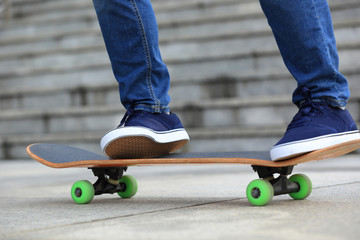Skateboarder legs skateboarding at city