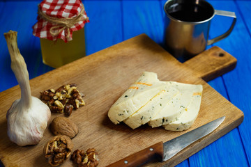 Slices of spicy cheese, served with walnuts,garlic and mug of homemade wine.