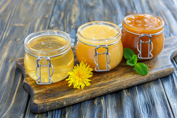Different varieties of honey in a glass jars.
