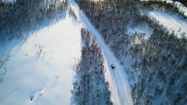 Red car driving on country road in norway