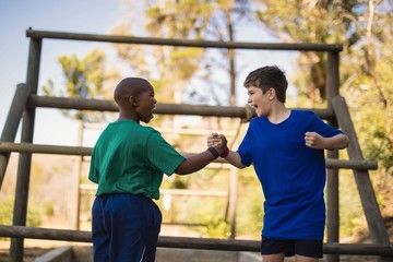 Happy boys cheering during obstacle course