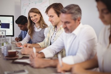 Businesswoman with colleagues in conference room