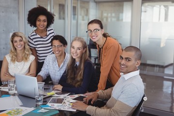Smiling colleagues planning in creative office
