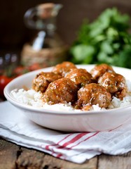 Beef meatballs with rice baked in tomato sauce.