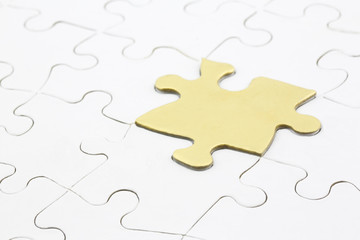 Golden puzzle piece marks smart answer to problems
